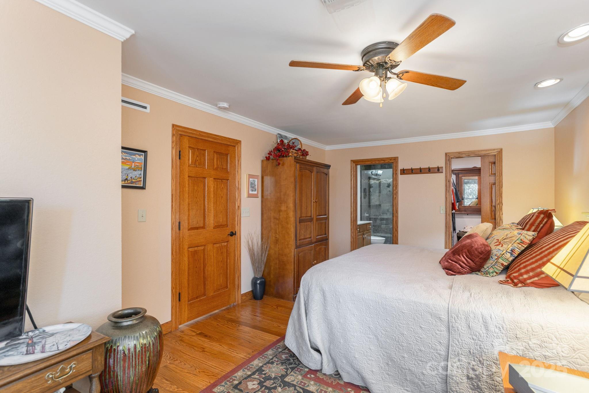 524 Three Mile Knob Road, Unit 3 Pisgah Forest, NC 28768 - Photo 27 of 33 a bedroom with a bed and a chandelier