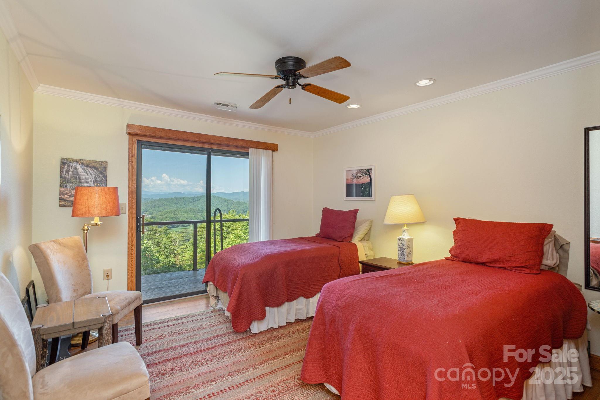 524 Three Mile Knob Road, Unit 3 Pisgah Forest, NC 28768 - Photo 30 of 33 a bedroom with two beds and a large window