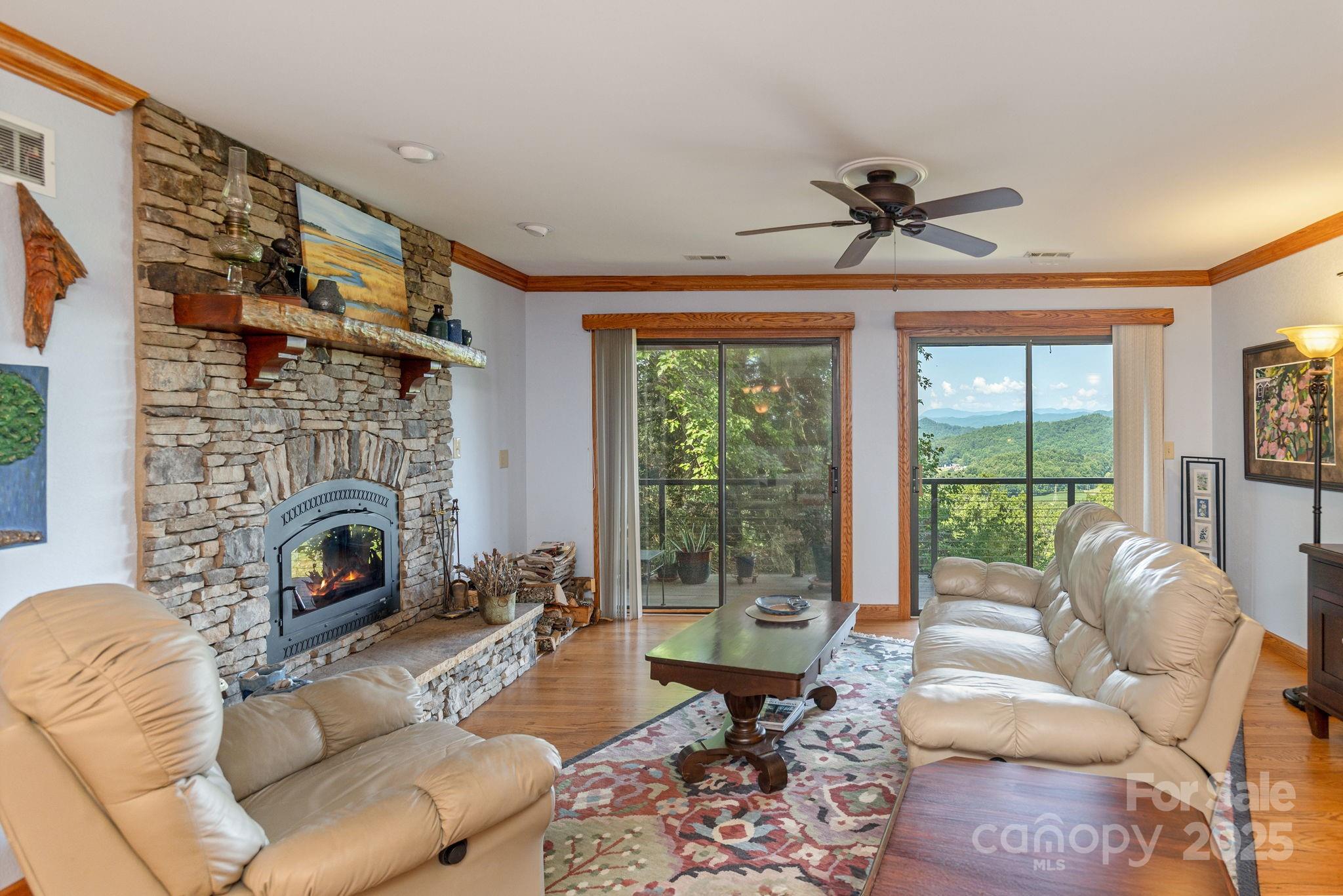 524 Three Mile Knob Road, Unit 3 Pisgah Forest, NC 28768 - Photo 10 of 33 a living room with furniture a fireplace and a floor to ceiling window