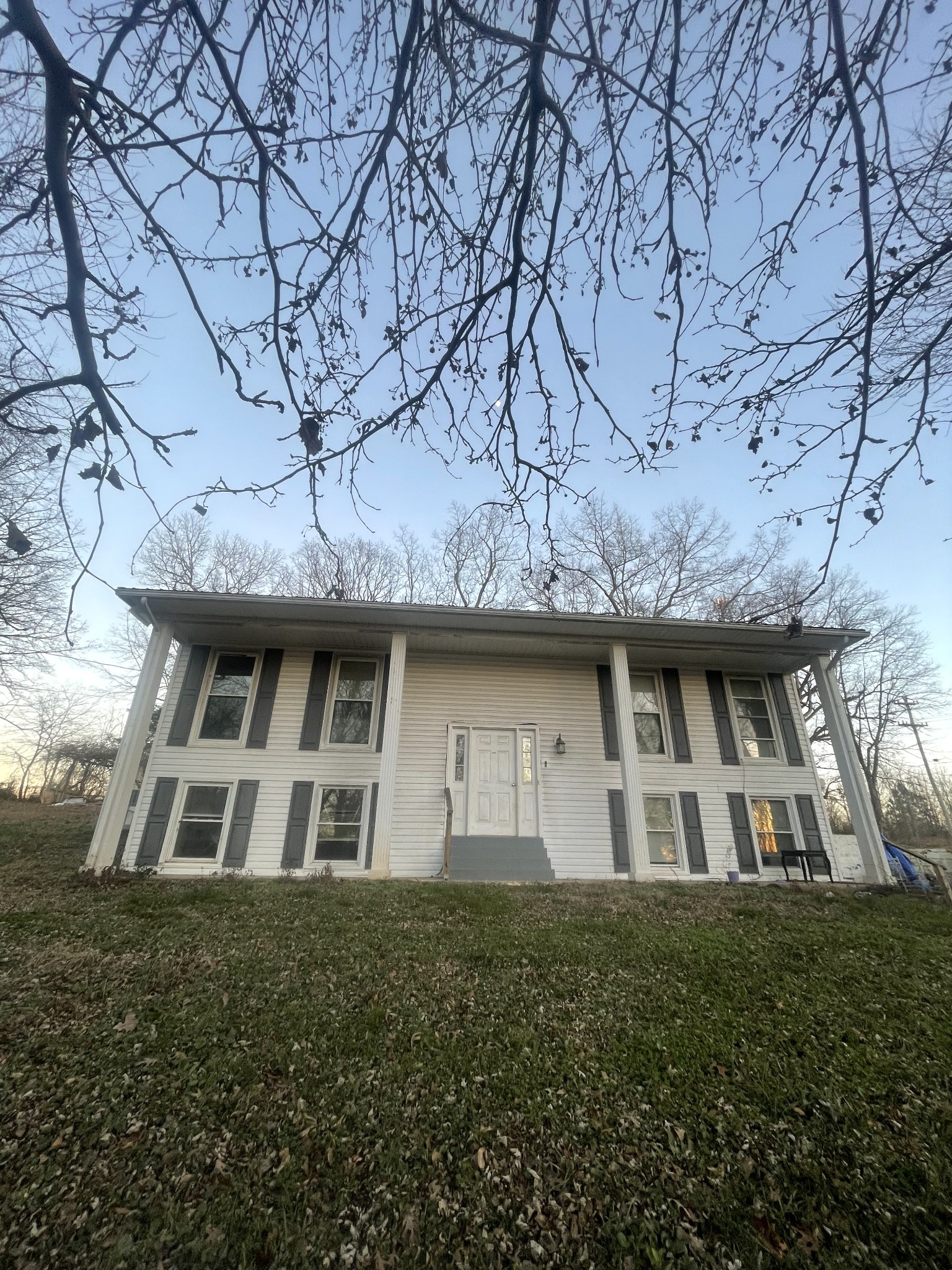 109 Beasley Road Lawrenceburg, TN 38464 - Photo 2 of 3 a view of a white house with a large tree