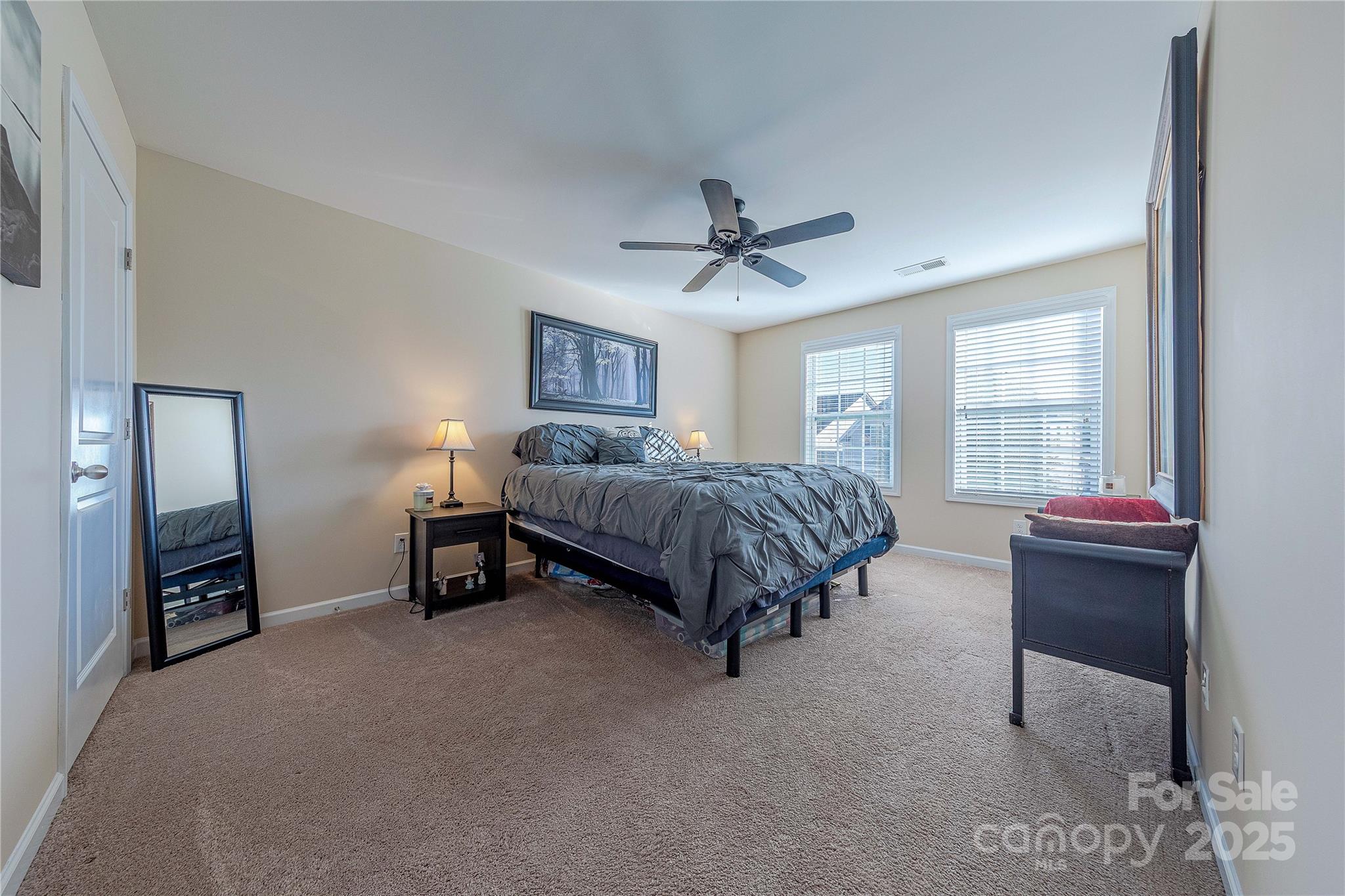 8344 Dallas Bay Road Charlotte, NC 28278 - Photo 21 of 25 a bedroom with a bed and a chandelier