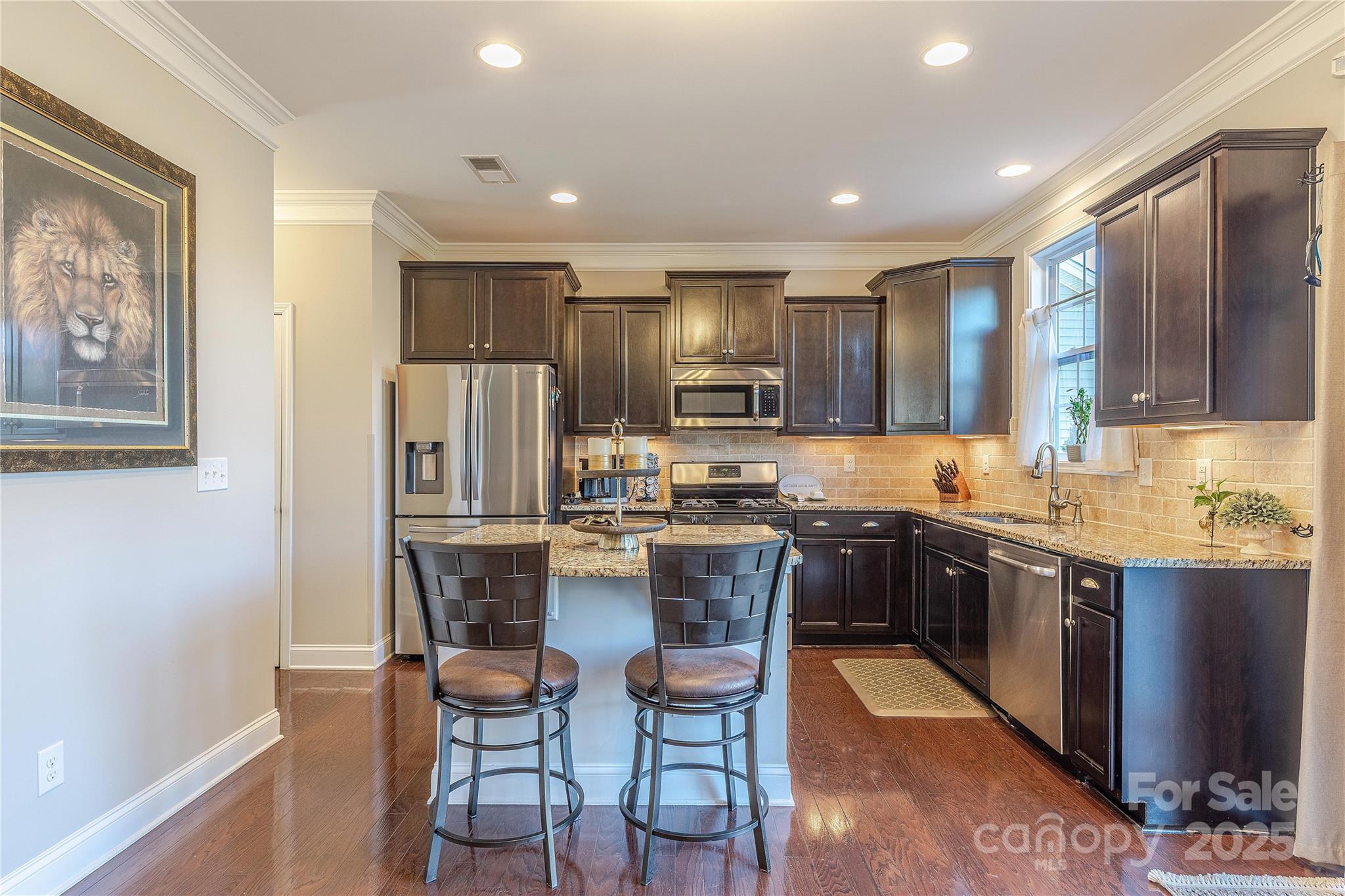 8344 Dallas Bay Road Charlotte, NC 28278 - Photo 9 of 25 a kitchen with kitchen island granite countertop wooden cabinets and stainless steel appliances