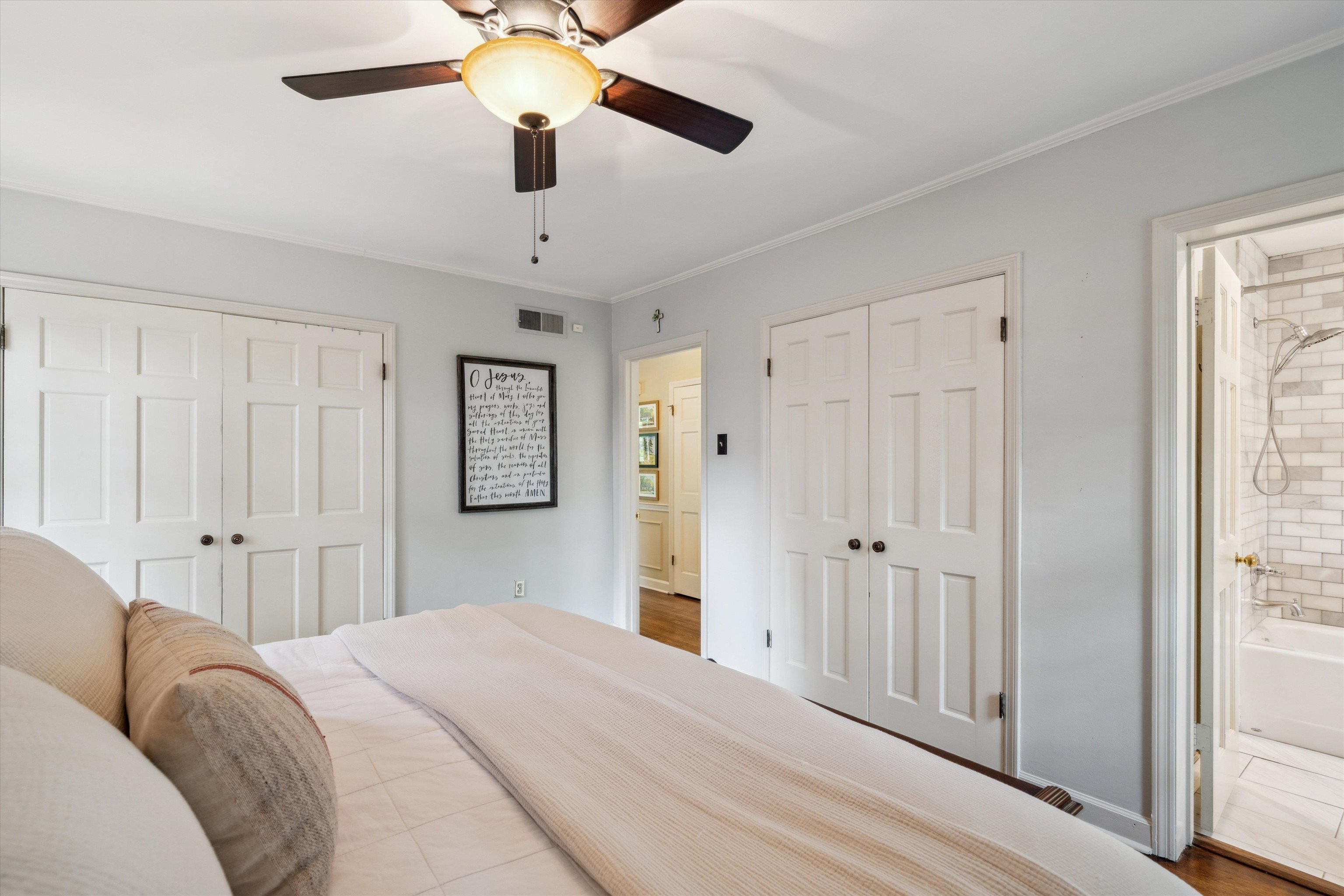 5265 South Angela Road Memphis, TN 38120 - Photo 13 of 26 a bedroom with a large bed and a chandelier