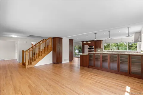 a kitchen with stainless steel appliances granite countertop a stove and a wooden floors