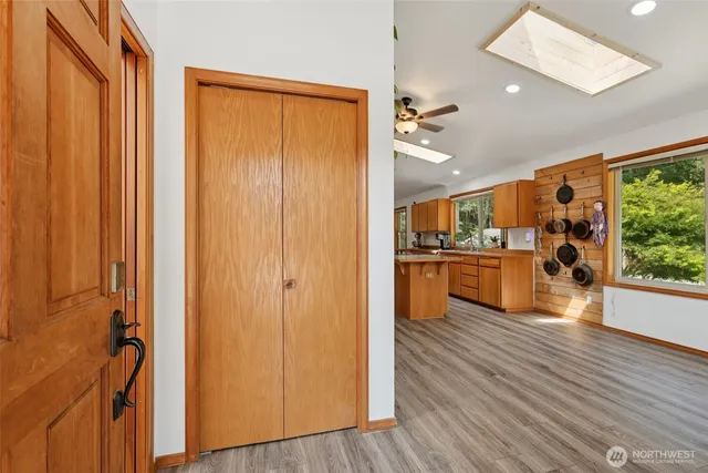 a kitchen with a stove a sink a refrigerator and a view of living room
