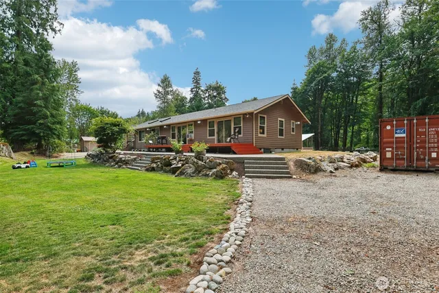 a view of a house with backyard and sitting area