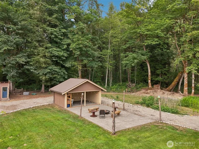 a view of kitchen dining table a sink a refrigerator and window