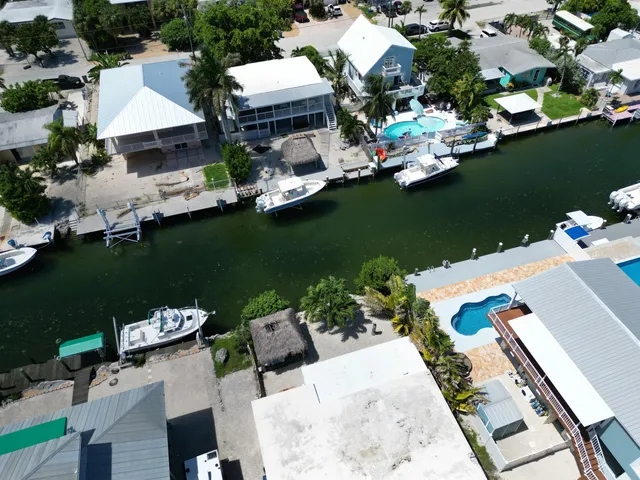 an aerial view of a house with ocean view