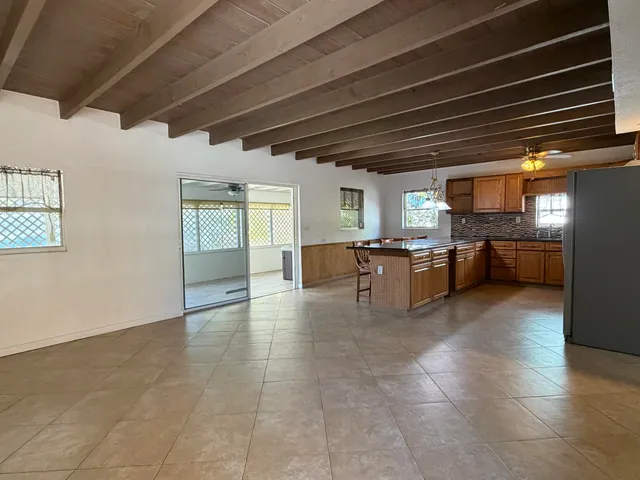 a large kitchen with stainless steel appliances granite countertop a stove a sink dishwasher and a refrigerator