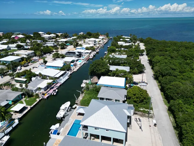 an aerial view of multiple house with ocean view