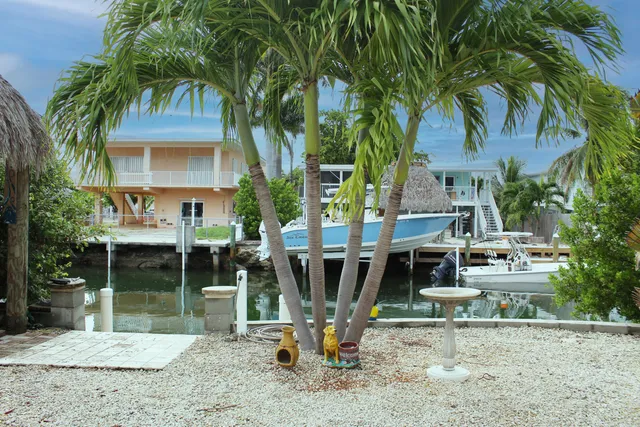 a view of a house with backyard porch and sitting area