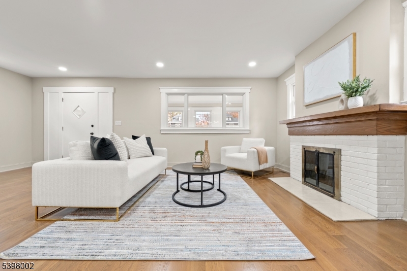 a living room with furniture a window and a fireplace