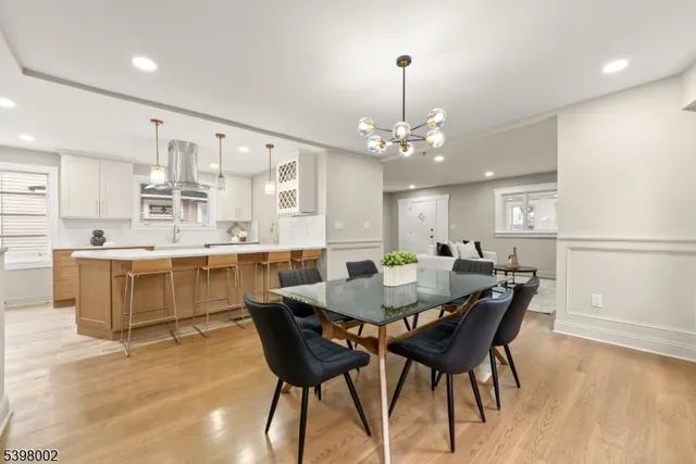 a view of a dining room with furniture and chandelier