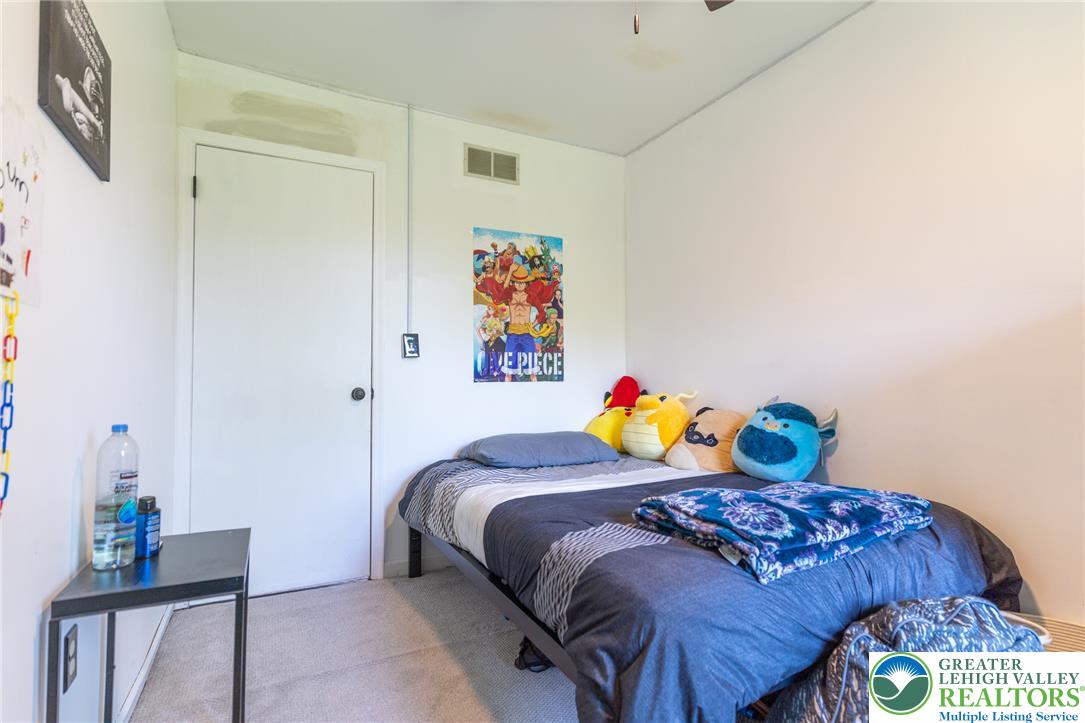 896 Briarstone Road Bethlehem, PA 18017 - Photo 15 of 26 a bed sitting in a bedroom next to a window