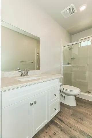 a bathroom with a toilet a sink and shower