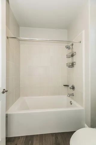 a bathroom with a bathtub and a shower