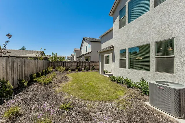 a view of a house with backyard and sitting area