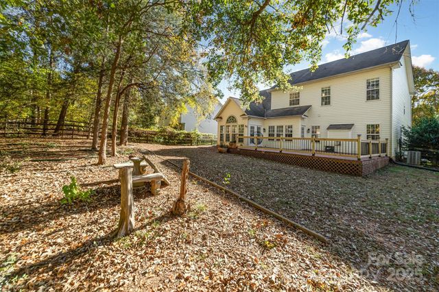 a view of house with backyard and seating area