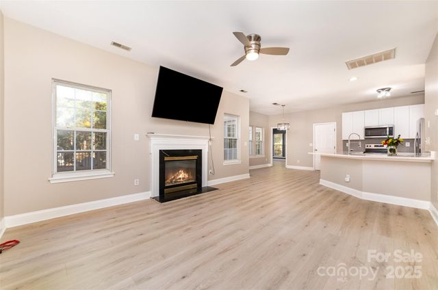 a view of a livingroom with a fireplace a microwave and a view