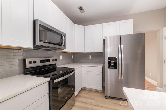 a kitchen with a refrigerator stove and microwave