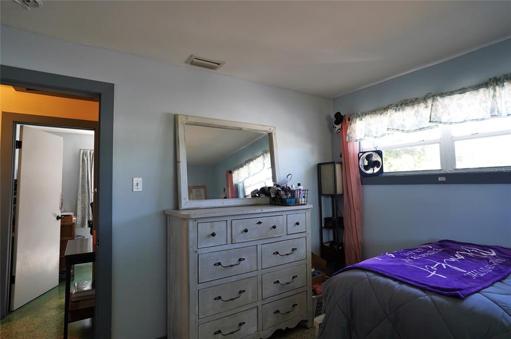 2357 Talbrook Terrace Punta Gorda, FL 33983 - Photo 13 of 55 a bedroom with a bed and a dresser
