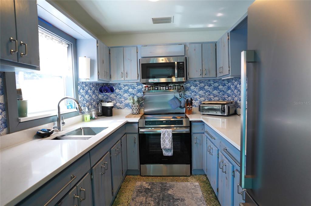 2357 Talbrook Terrace Punta Gorda, FL 33983 - Photo 18 of 55 a kitchen with stainless steel appliances granite countertop a sink stove and refrigerator