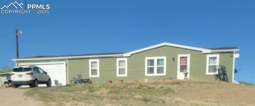 View of front of home featuring an attached garage and driveway