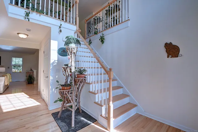 a view of entryway and hall with wooden floor
