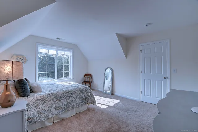 a bedroom with a large bed and a window