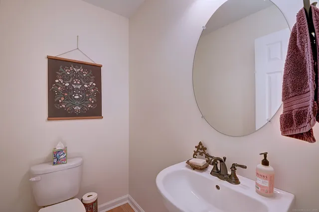 a bathroom with a sink mirror and toilet