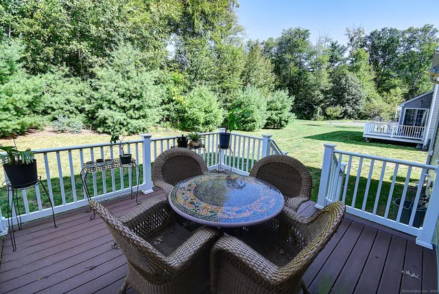 a view of a deck with a table and chairs with wooden floor