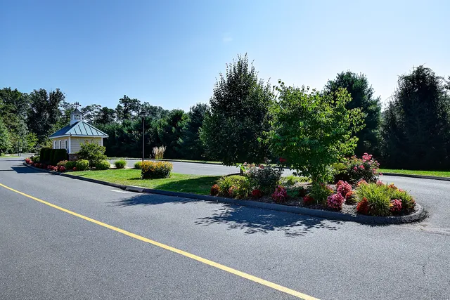 a front view of a house with a yard and outdoor seating