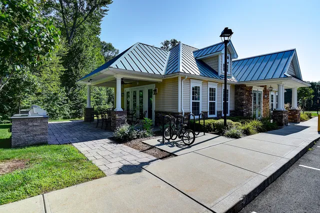 a front view of house with yard and outdoor seating