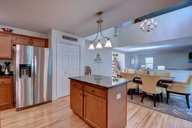 a kitchen with a counter space dining table and wooden floor