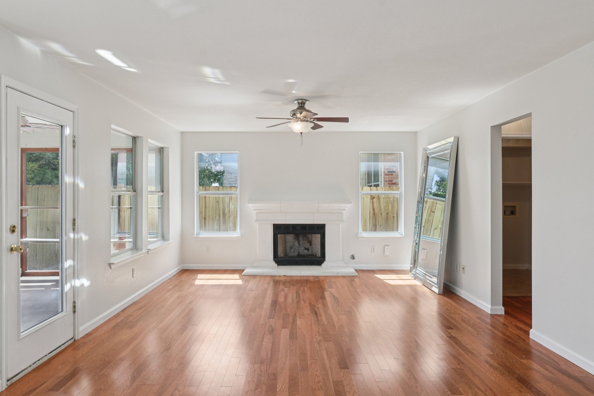 14521 Ballycastle Trail Austin, TX 78717 - Photo 11 of 40 a view of a livingroom with a fireplace window and wooden floor
