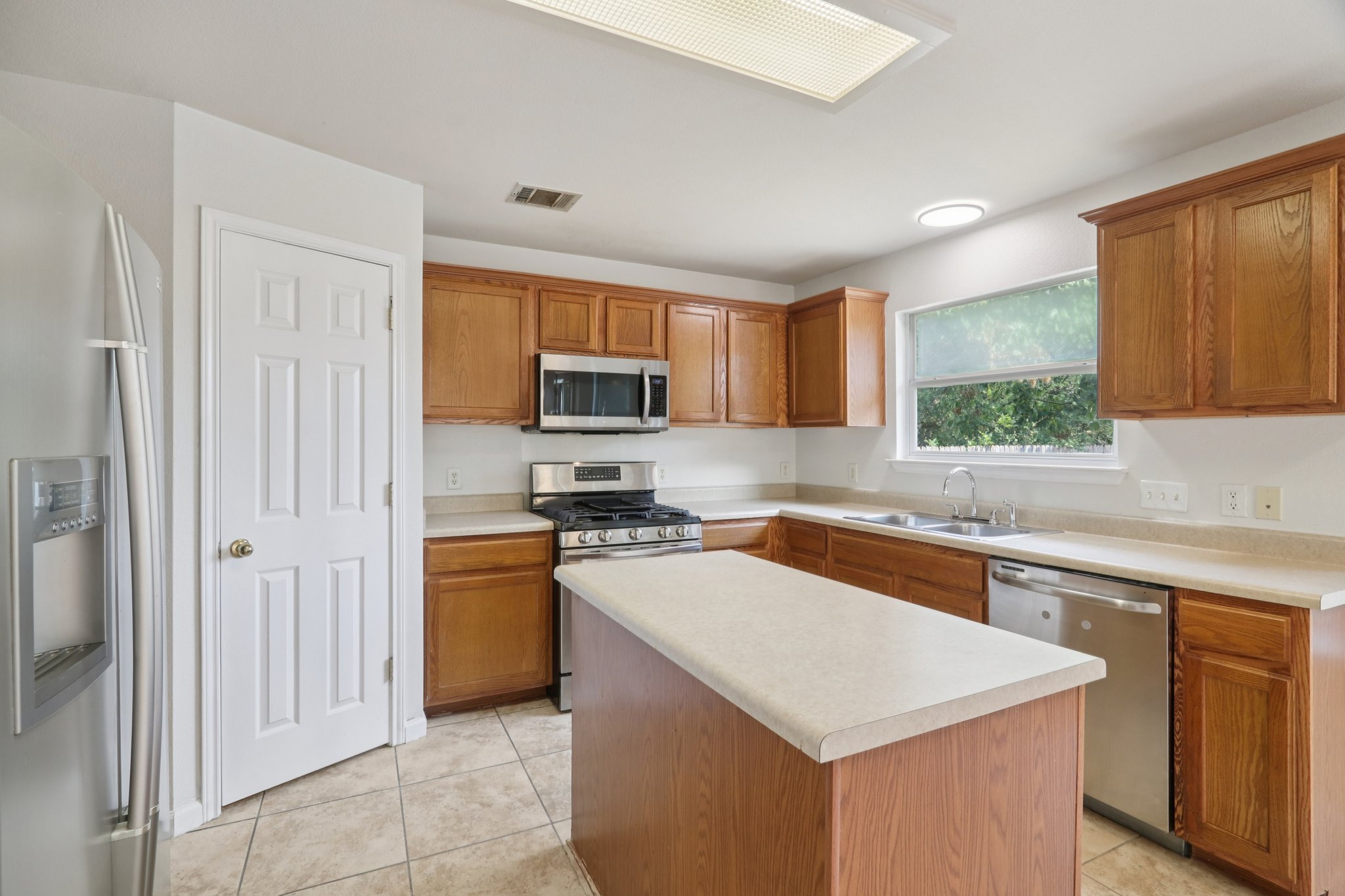 14521 Ballycastle Trail Austin, TX 78717 - Photo 13 of 40 a kitchen with a sink a stove top oven and cabinetry