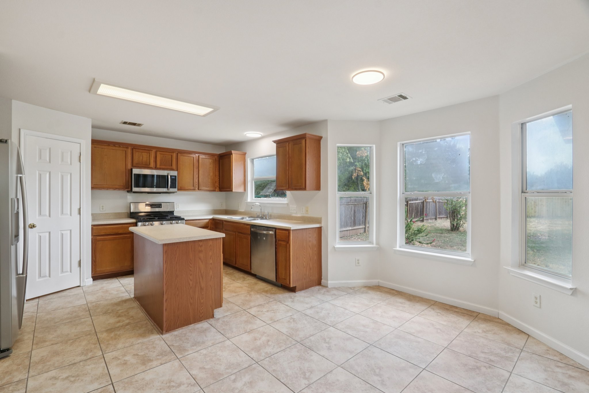 14521 Ballycastle Trail Austin, TX 78717 - Photo 17 of 40 a kitchen with a refrigerator and a stove top oven