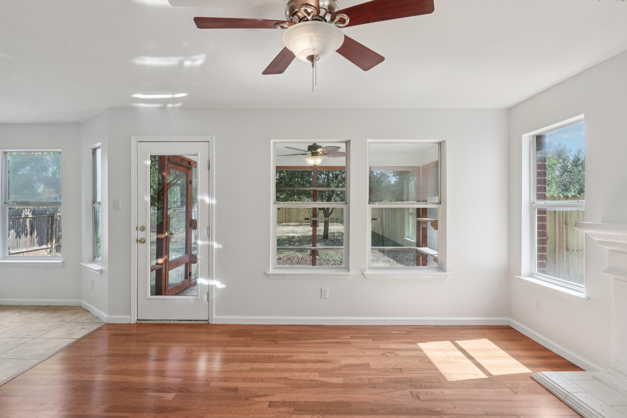 14521 Ballycastle Trail Austin, TX 78717 - Photo 19 of 40 a view of an empty room with window and wooden floor