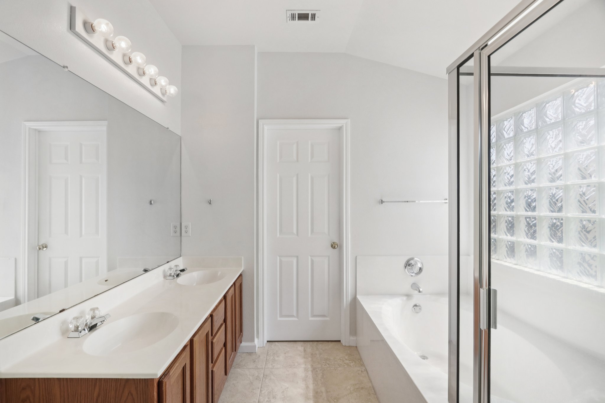 14521 Ballycastle Trail Austin, TX 78717 - Photo 36 of 40 a bathroom with a tub a sink and mirrors