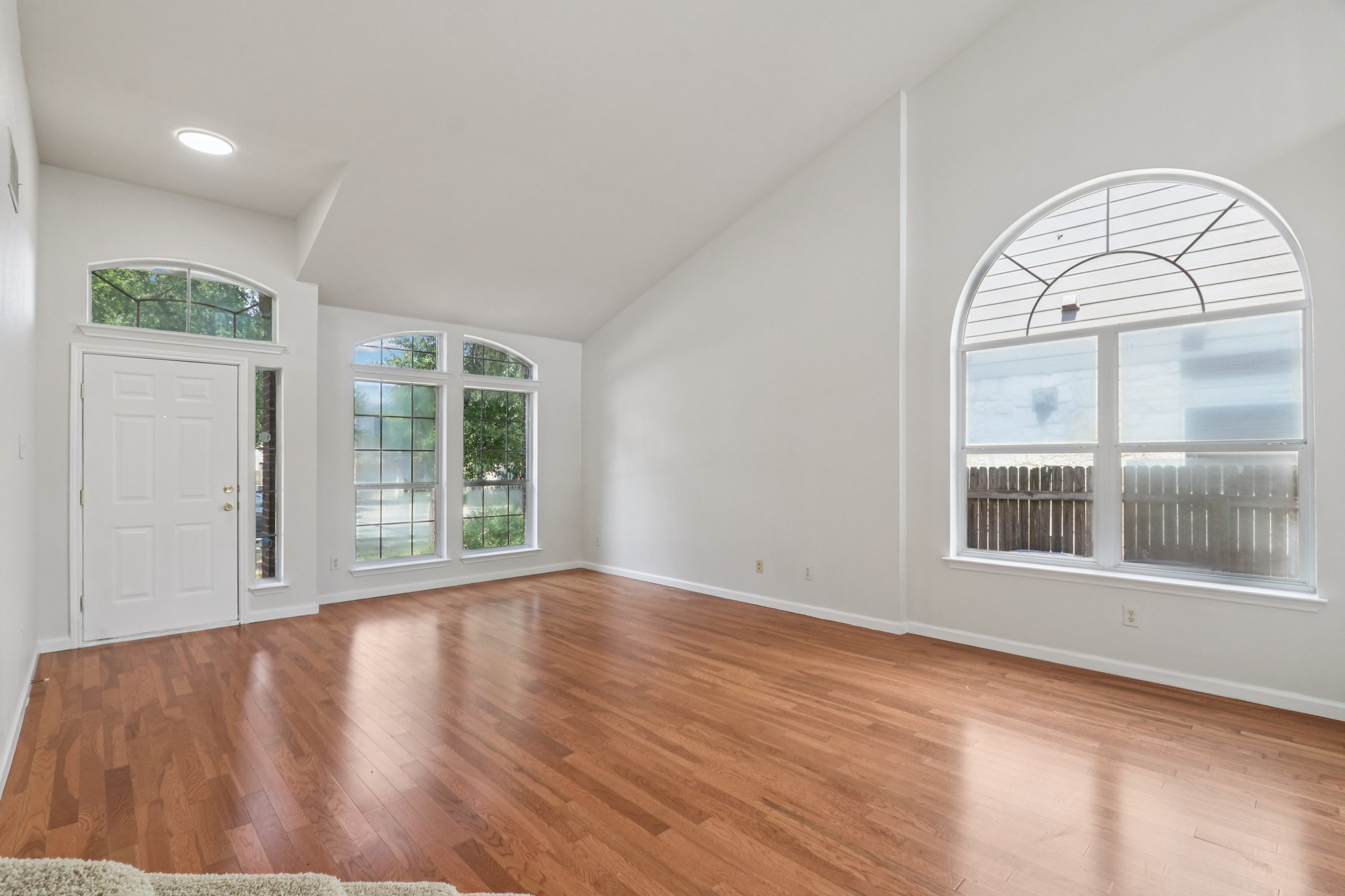 14521 Ballycastle Trail Austin, TX 78717 - Photo 8 of 40 an empty room with wooden floor and a large window
