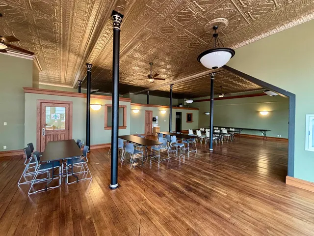 a dining room with furniture and wooden floor