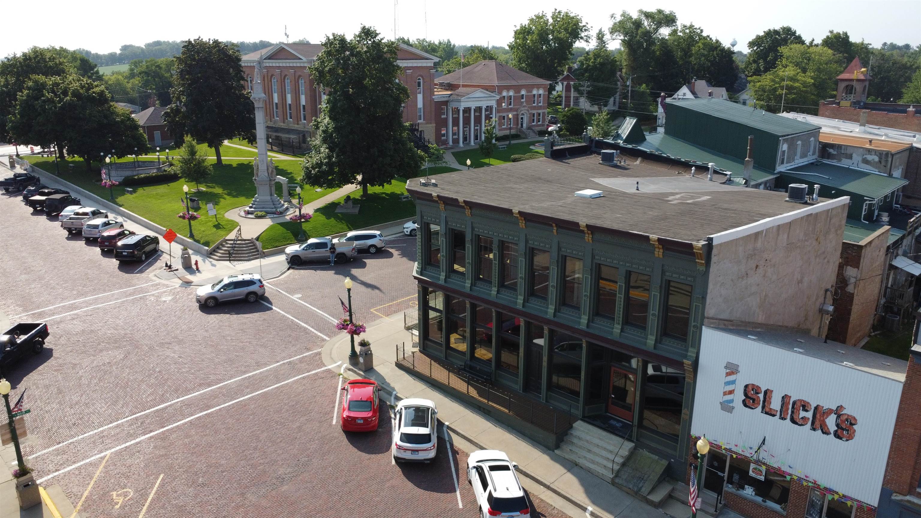 320 North Main Street Mount Carroll, IL 61053 - Photo 28 of 31 a view of a patio with table and chairs potted plants with wooden floor