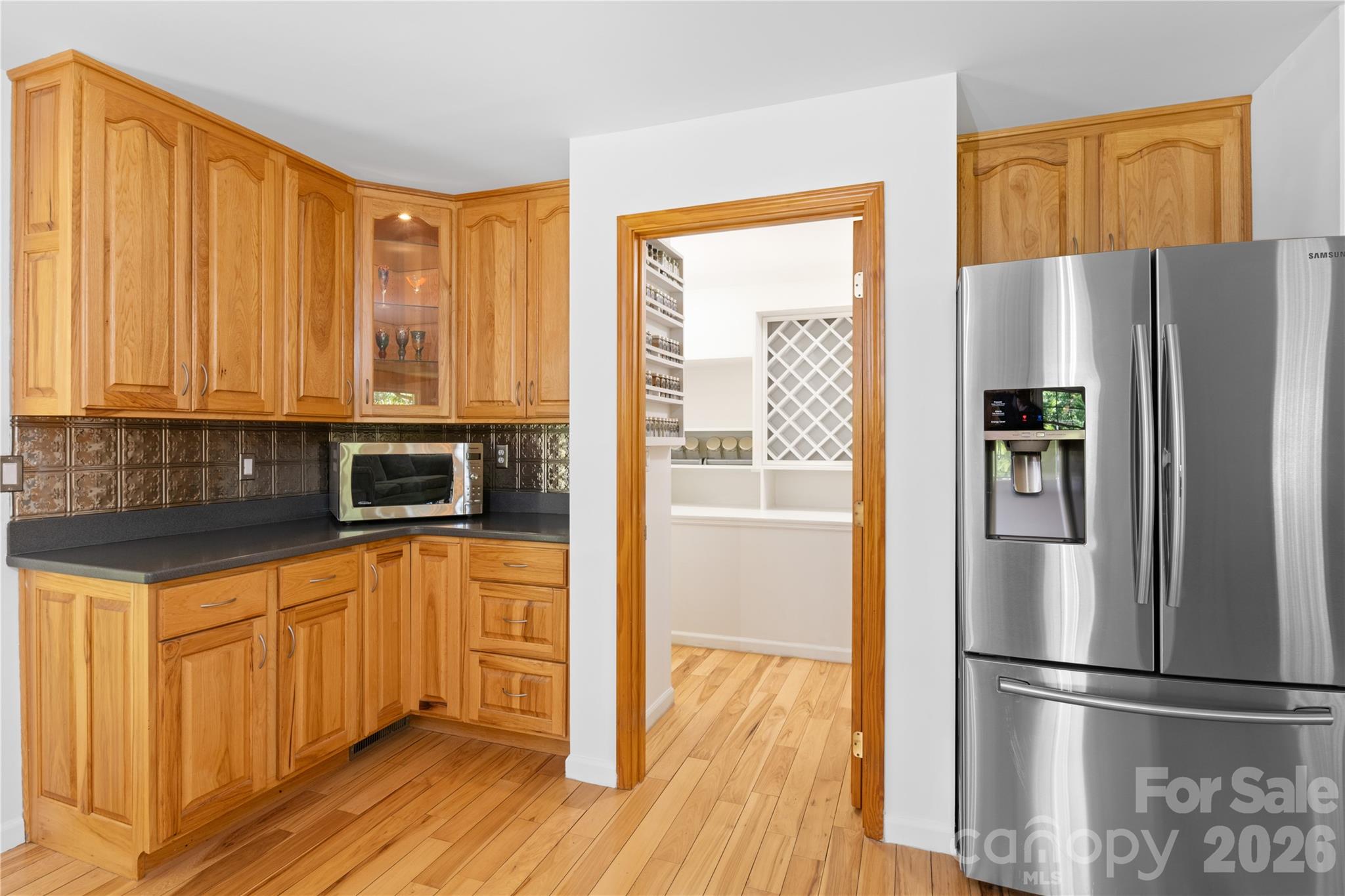 3 Northwood Road Asheville, NC 28804 - Photo 18 of 48 a kitchen with stainless steel appliances granite countertop a refrigerator a stove and a sink with wooden floor