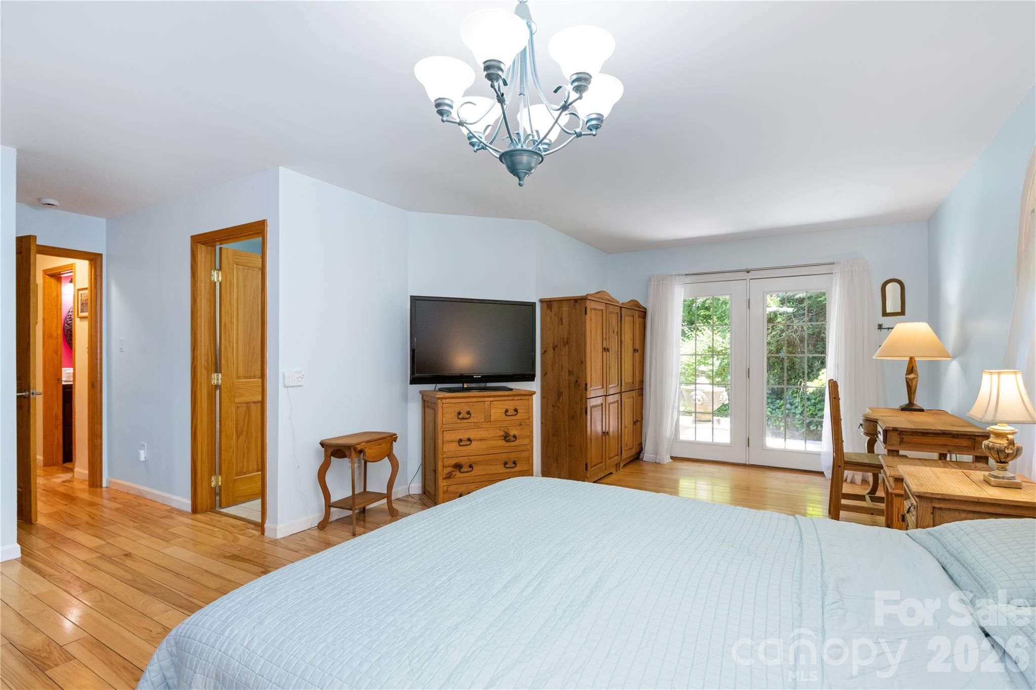 3 Northwood Road Asheville, NC 28804 - Photo 21 of 48 a bedroom with a bed and a flat tv screen on dresser