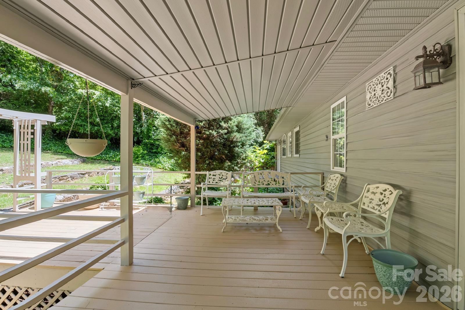 3 Northwood Road Asheville, NC 28804 - Photo 43 of 48 a view of a patio with table and chairs potted plants with wooden floor and fence