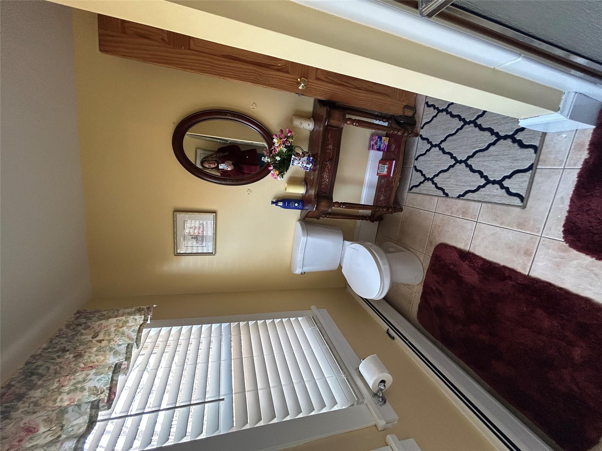 199 Washington Street Poughkeepsie, NY 12601 - Photo 21 of 32 Bathroom featuring tile patterned flooring, toilet, and baseboard heating