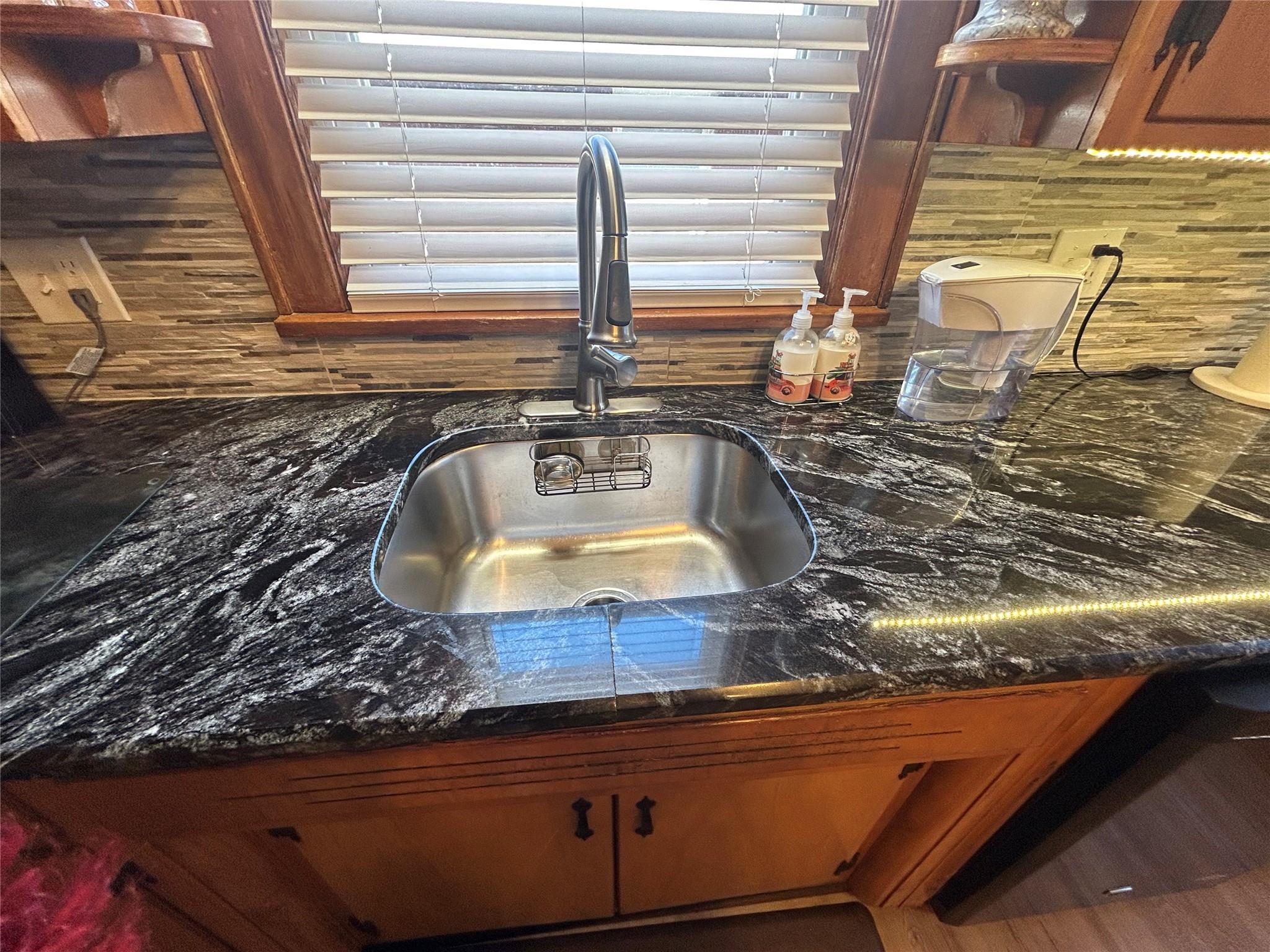 199 Washington Street Poughkeepsie, NY 12601 - Photo 4 of 32 Interior details with tasteful backsplash, dark stone countertops, and a sink