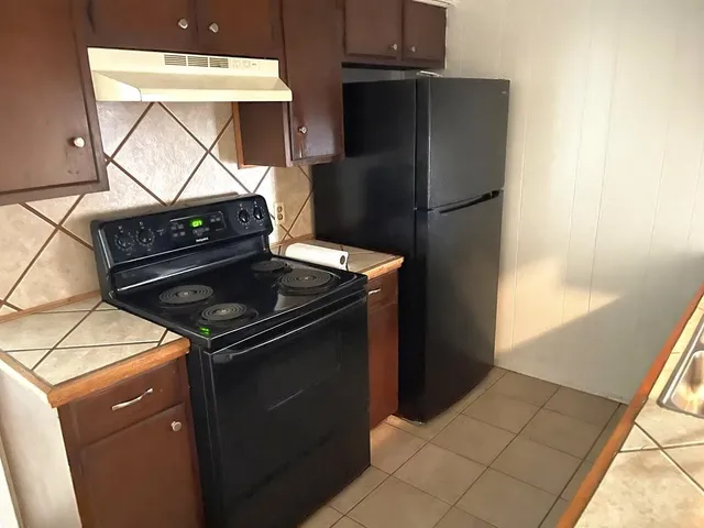 a close view of stove top oven and refrigerator
