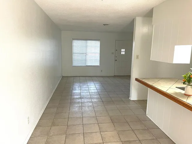 a view of a kitchen with a sink and a window