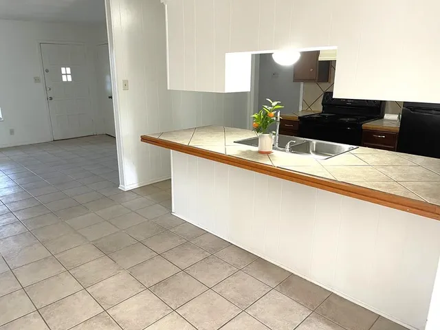 a kitchen with a sink and cabinets